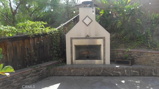 view of patio featuring an outdoor fireplace