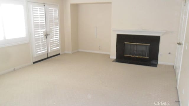 unfurnished living room with light colored carpet