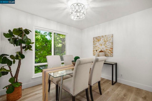 dining area with a notable chandelier and light wood-type flooring