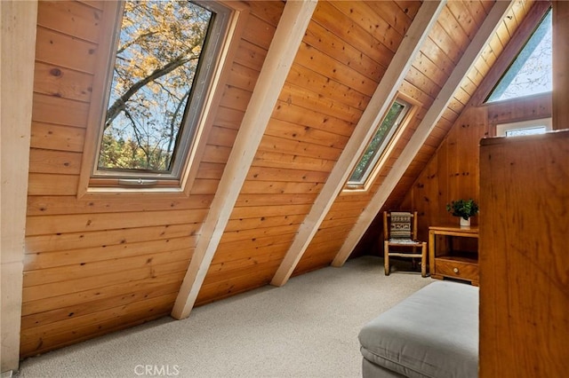 bonus room with vaulted ceiling with skylight, wooden walls, wood ceiling, and carpet