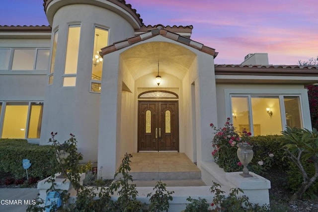 view of exterior entry at dusk