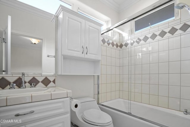 full bathroom with toilet, bath / shower combo with glass door, crown molding, and vanity