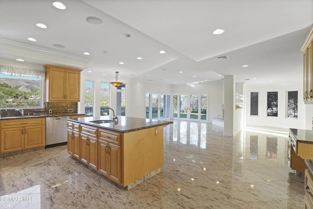 kitchen featuring sink, a center island with sink, dishwasher, and dark stone counters