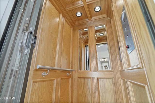 room details featuring coffered ceiling, wooden ceiling, and elevator