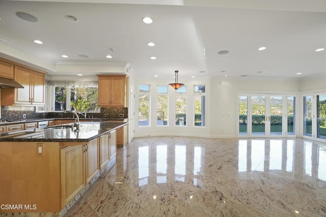 kitchen featuring pendant lighting, french doors, tasteful backsplash, crown molding, and dark stone countertops