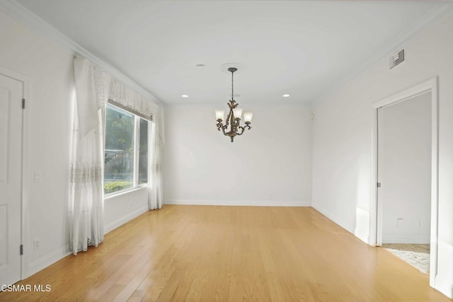 spare room with a notable chandelier, crown molding, and wood-type flooring