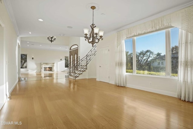 interior space featuring ornamental molding, light hardwood / wood-style flooring, and an inviting chandelier