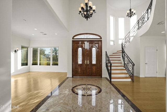 entrance foyer featuring a chandelier and ornamental molding