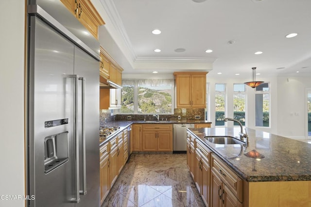 kitchen featuring stainless steel appliances, sink, a center island, tasteful backsplash, and hanging light fixtures