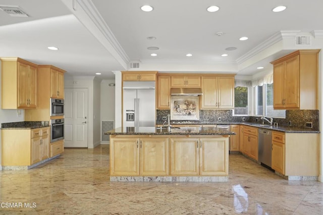 kitchen with stainless steel appliances, dark stone countertops, a kitchen island with sink, and crown molding