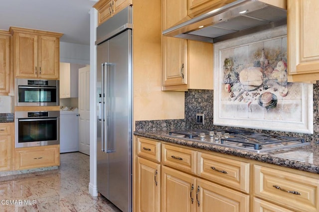 kitchen with light brown cabinets, dark stone countertops, decorative backsplash, extractor fan, and appliances with stainless steel finishes