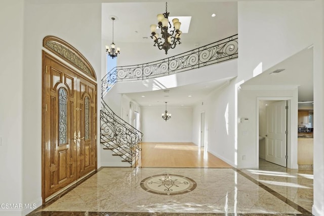 entryway with a high ceiling and crown molding