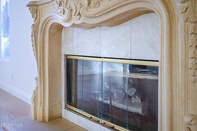 interior details with a tile fireplace