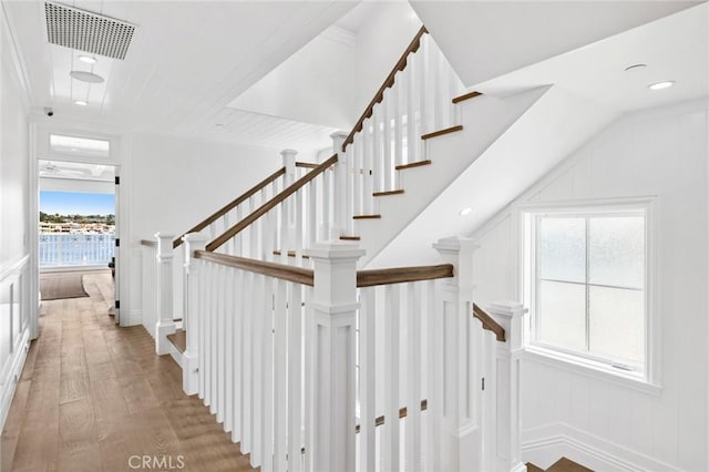 930 E Balboa Blvd, Newport Beach, CA 92661 - stairway with hardwood / wood-style flooring, a decorative wall, and recessed lighting