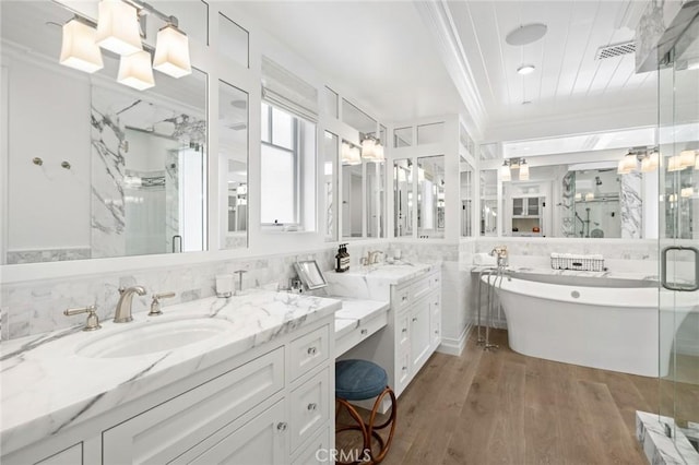 930 E Balboa Blvd, Newport Beach, CA 92661 - full bathroom with crown molding, a marble finish shower, a freestanding bath, vanity, and wood finished floors
