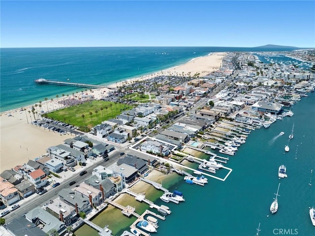 drone / aerial view featuring a water view and a beach view