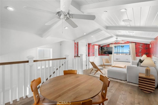 interior space featuring vaulted ceiling with beams and light hardwood / wood-style flooring