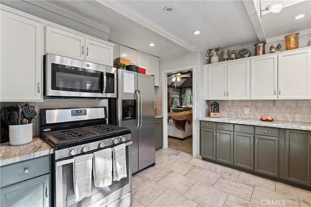 kitchen with white cabinetry, ceiling fan, stainless steel appliances, tasteful backsplash, and beamed ceiling