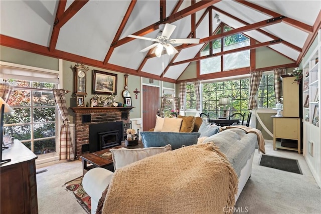 living room with beamed ceiling, light colored carpet, a wood stove, and high vaulted ceiling