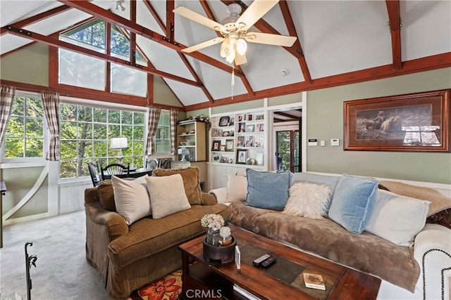 carpeted living room with beam ceiling, high vaulted ceiling, and ceiling fan