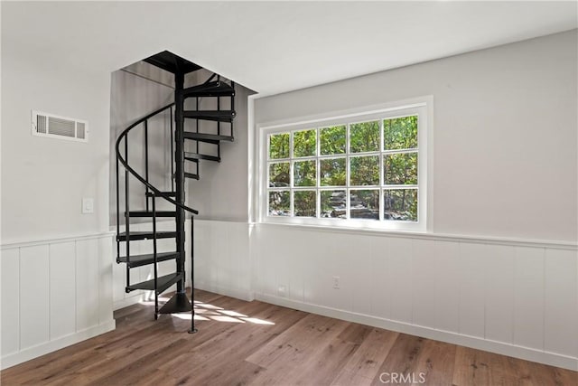 staircase with hardwood / wood-style flooring