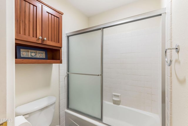 bathroom featuring toilet and enclosed tub / shower combo