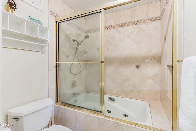 bathroom with shower / bath combination with glass door and toilet