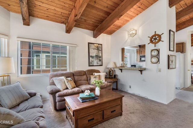 carpeted living room featuring vaulted ceiling with beams and wooden ceiling