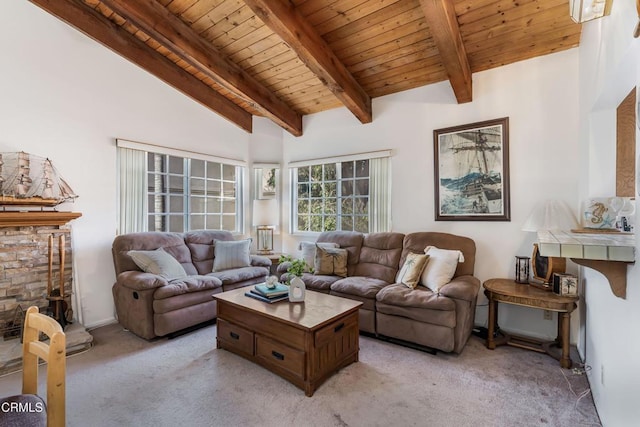 carpeted living room with beam ceiling, a stone fireplace, wooden ceiling, and high vaulted ceiling