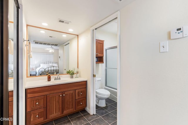 full bathroom featuring vanity, bath / shower combo with glass door, tile patterned flooring, ceiling fan, and toilet