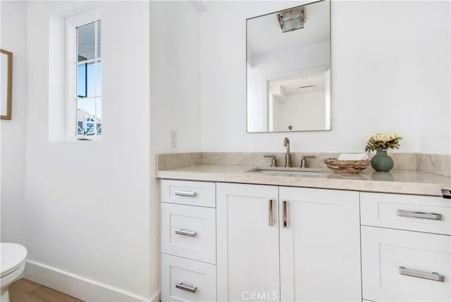 bathroom featuring vanity and toilet