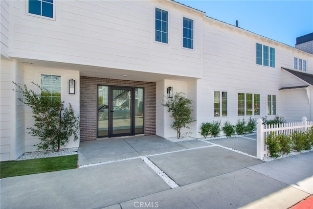 view of exterior entry with a patio area