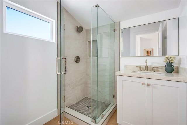 bathroom with vanity, wood-type flooring, and walk in shower