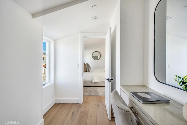 interior space featuring vaulted ceiling and light wood-type flooring