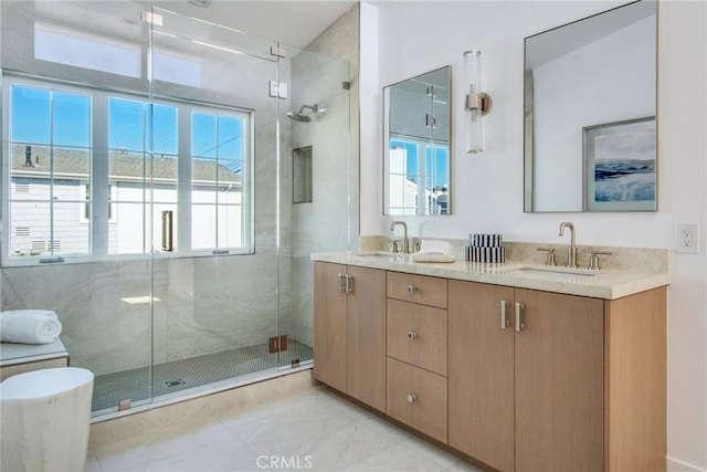 bathroom featuring vanity and an enclosed shower