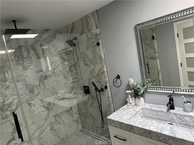 bathroom featuring vanity and a marble finish shower