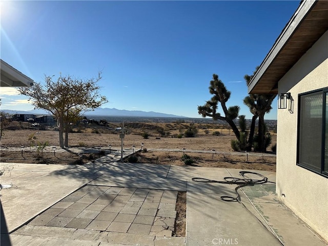 view of patio / terrace featuring a mountain view