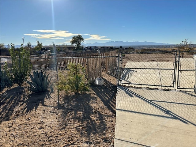 view of gate featuring fence and a mountain view