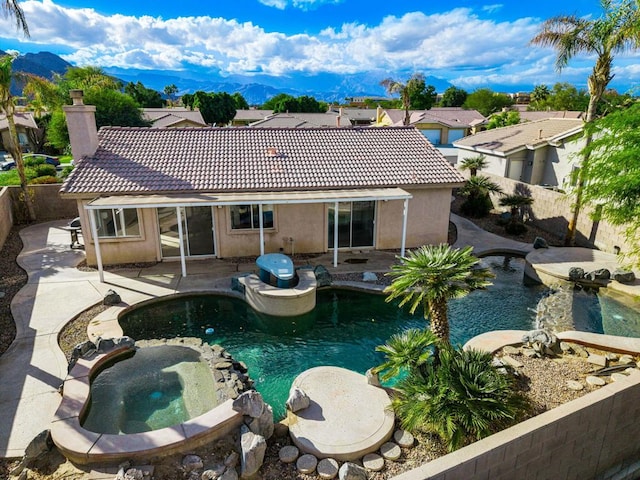 view of swimming pool with a mountain view, an in ground hot tub, and a patio