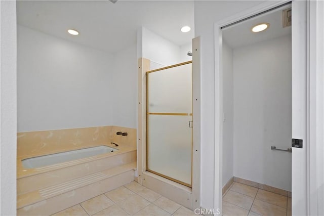 bathroom featuring tile patterned flooring and separate shower and tub