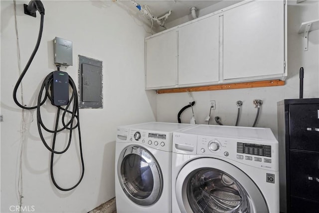 washroom with cabinets and washer and clothes dryer