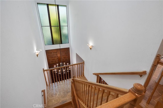 stairway featuring parquet floors