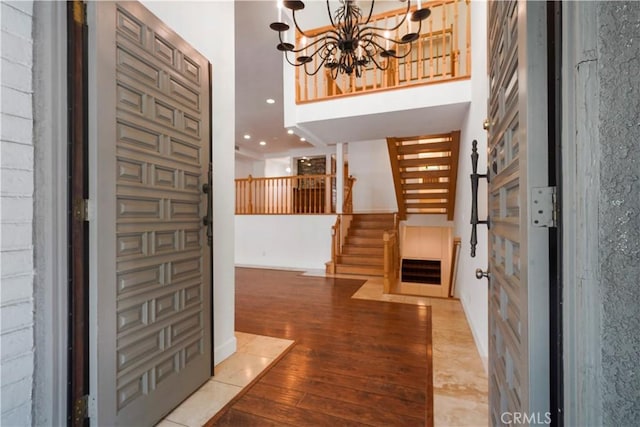 foyer entrance with light hardwood / wood-style flooring and a chandelier