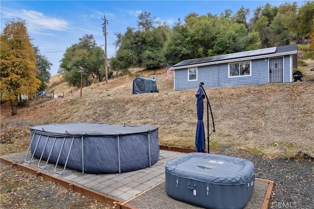 view of yard featuring an outbuilding and a covered pool