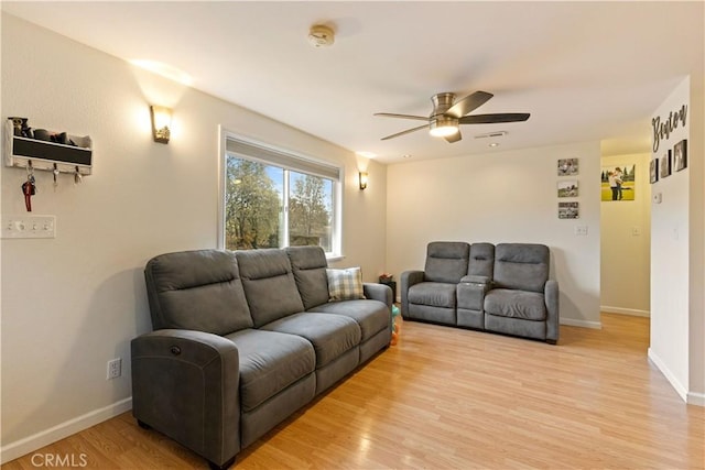 living room with ceiling fan and light hardwood / wood-style floors