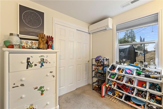 game room featuring a wall mounted air conditioner and carpet