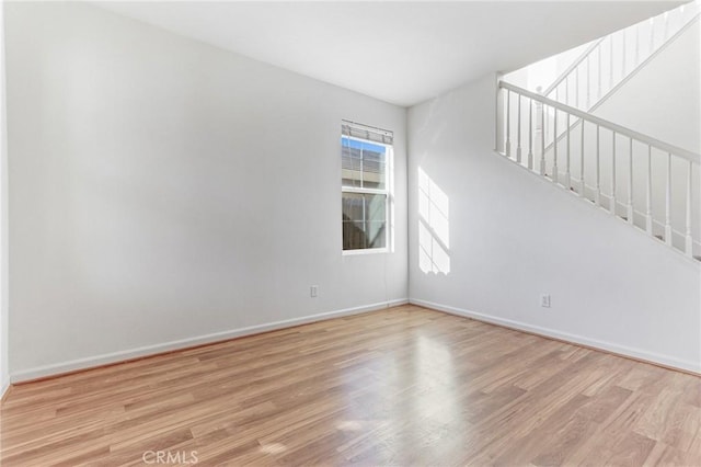 spare room with light hardwood / wood-style flooring