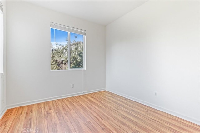 empty room with light hardwood / wood-style flooring