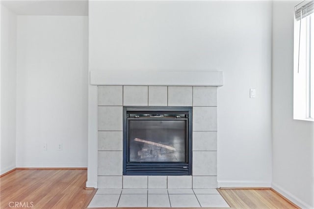 interior details featuring a fireplace and wood-type flooring