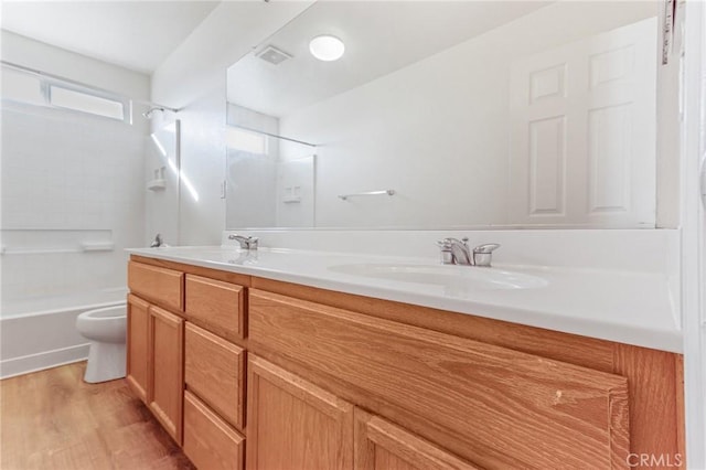 full bathroom with vanity, wood-type flooring, bathtub / shower combination, and toilet